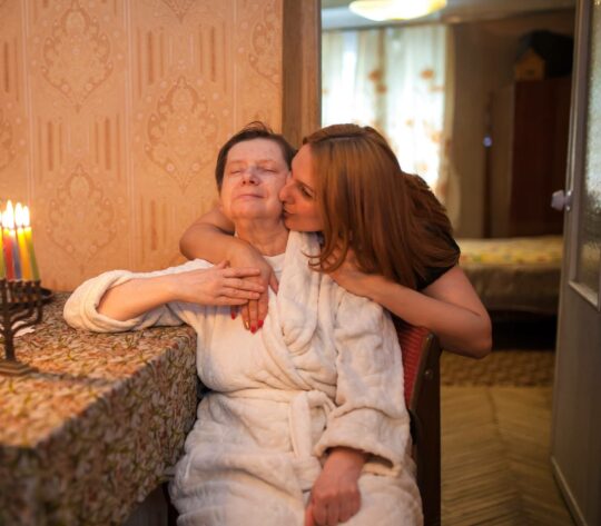 Younger woman hugging older woman