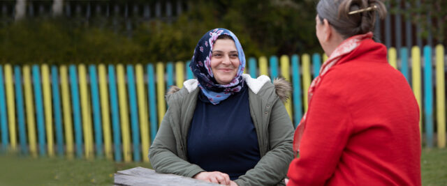 Two women talking and smiling