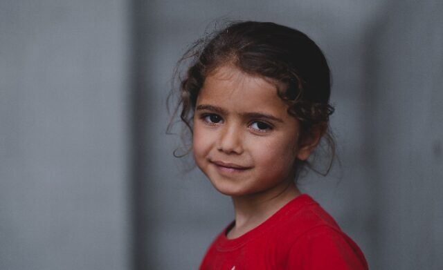 Young girl wearing a red top